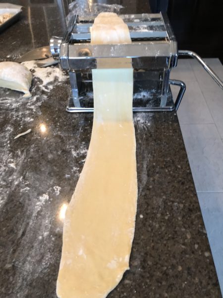 Stretching the pasta dough.